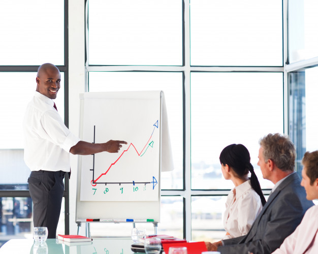 businessman-giving-a-presentation-to-his-team_13339-140392